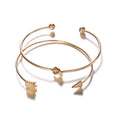 Gold electroplated alloy cuff bracelet with arrow and knot vintage design for women