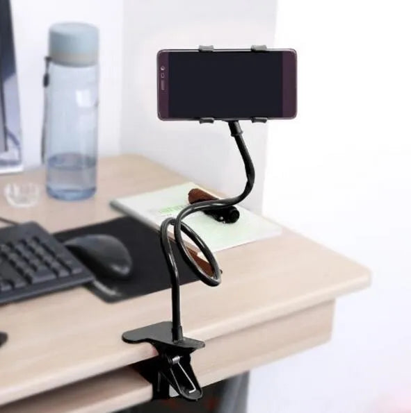 Black flexible long arm phone holder with V-clip attached to a bed frame, holding a smartphone.