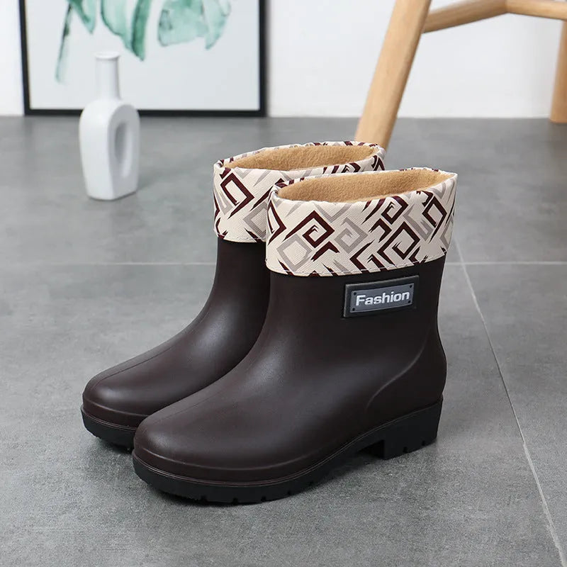 Women's mid-calf PVC rain boot in black, shown with a low heel and optional wool lining.