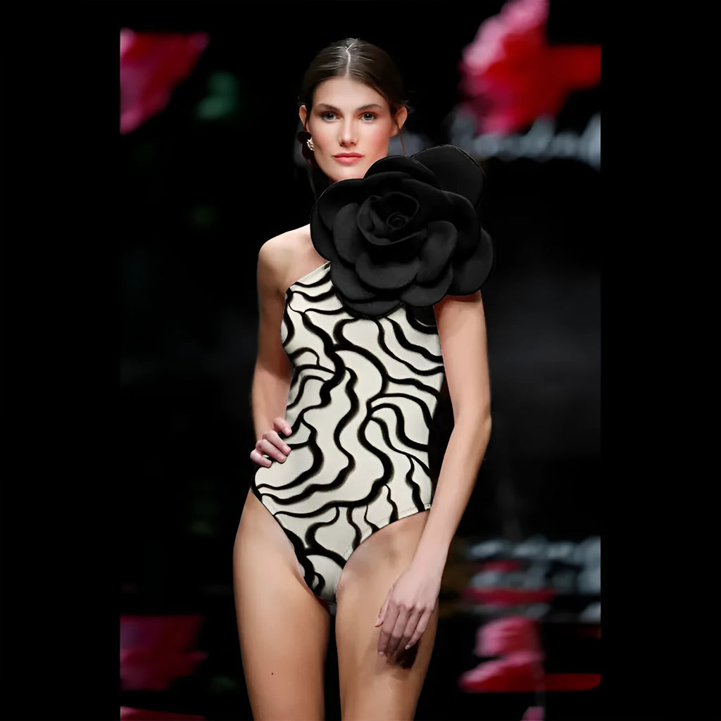 Close-up of a solid colour one-piece swimsuit with raised three-dimensional flower pattern detail