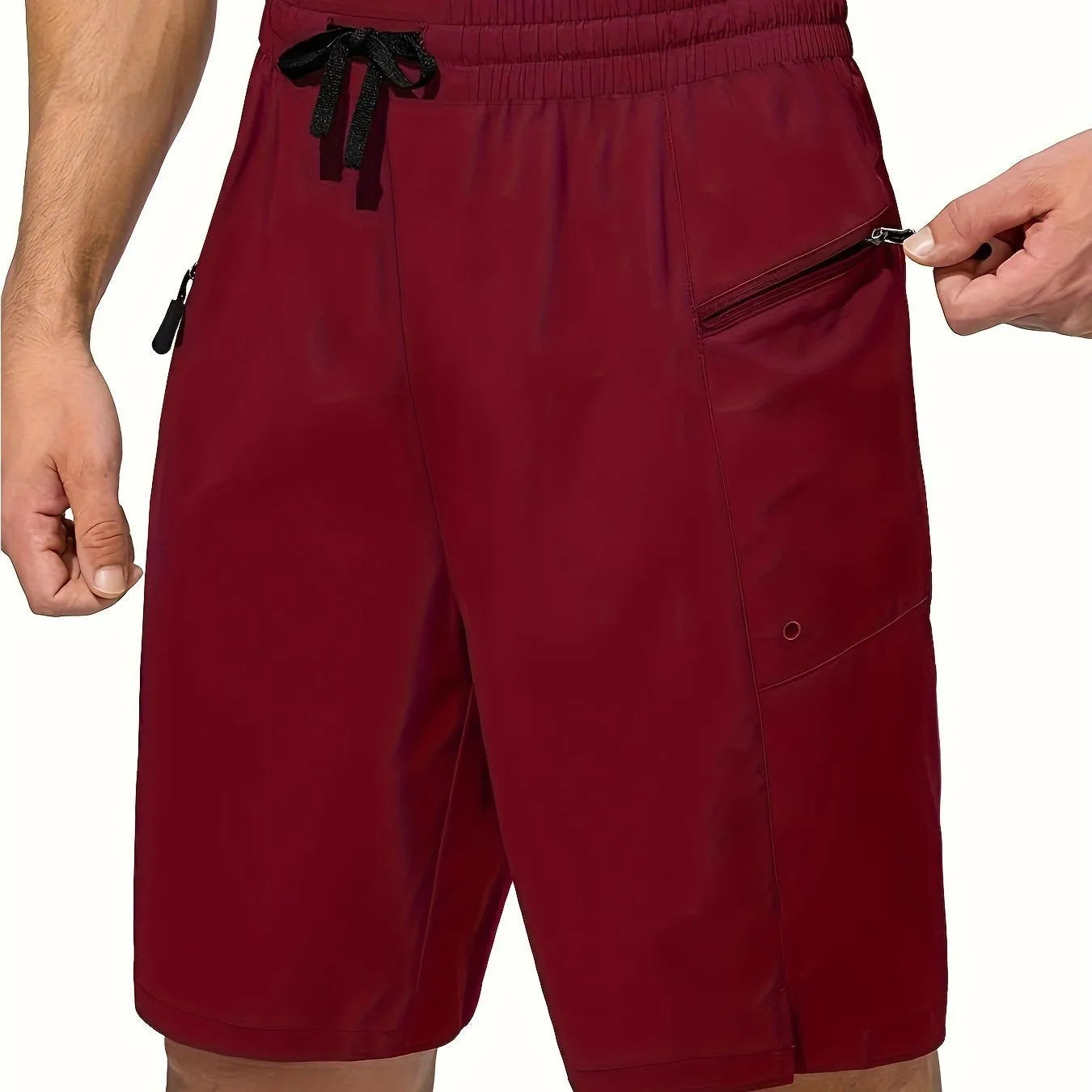 Man wearing solid colour quick-drying polyester beach shorts in a straight leg fit.