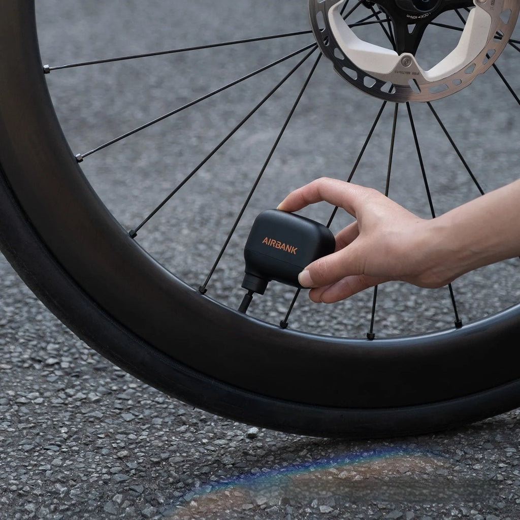 Black AS100 mini electric bike pump with USB cable and waterproof storage bag