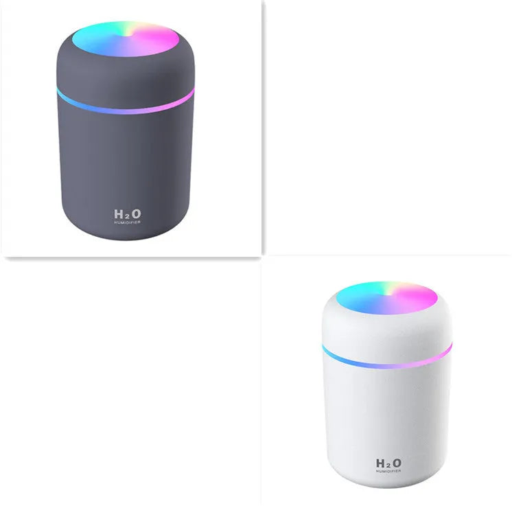 Pink USB mini humidifier with LED lights and water tank on desk