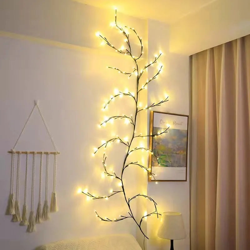 Flexible birch bark textured LED willow vine garland bent into shape with warm white lights.