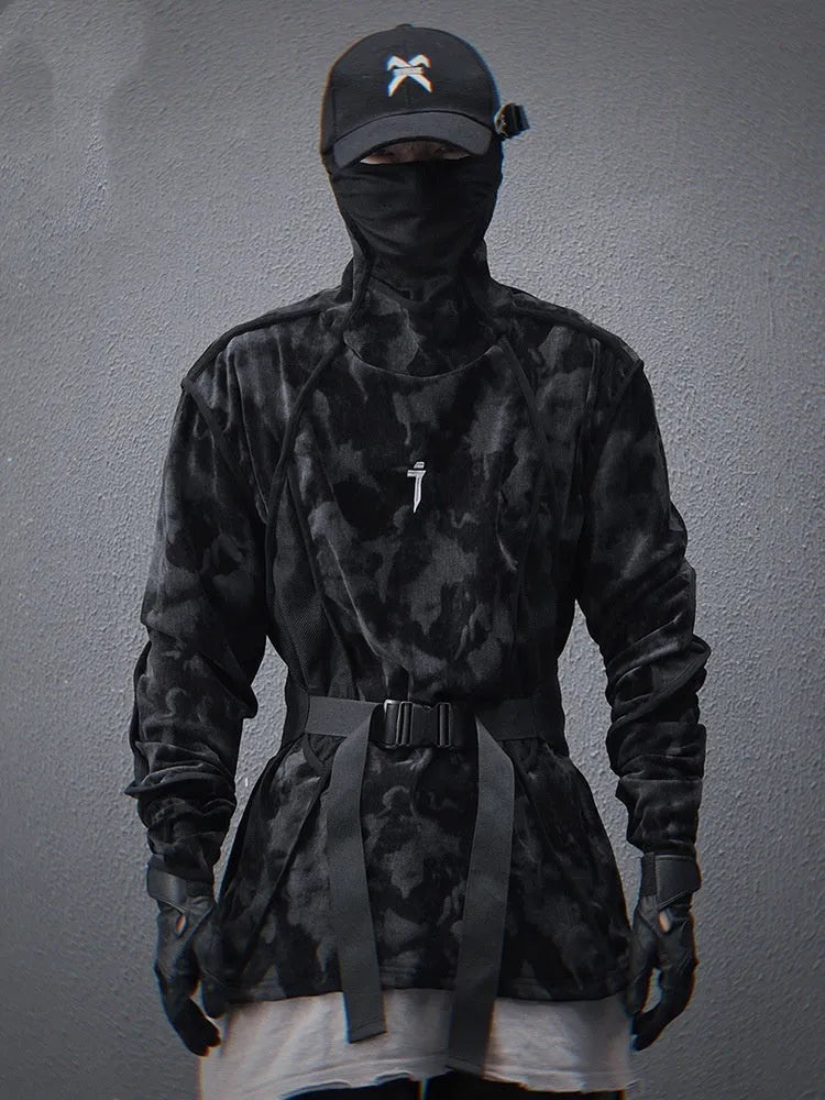 Man wearing a black and grey tie dye printed finger turtleneck sweater with drop shoulder sleeves.