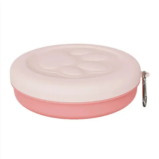 Portable outdoor dog food and water bowl with attached snack box in light pink and green colours.