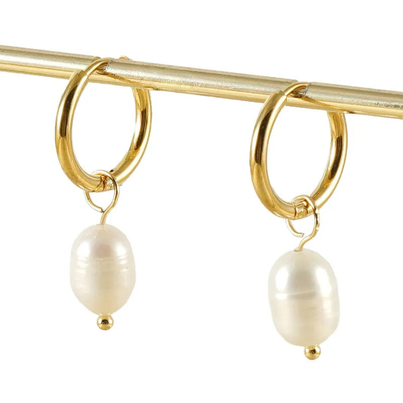 Geometric gold stainless steel earrings with pearl accents on white background