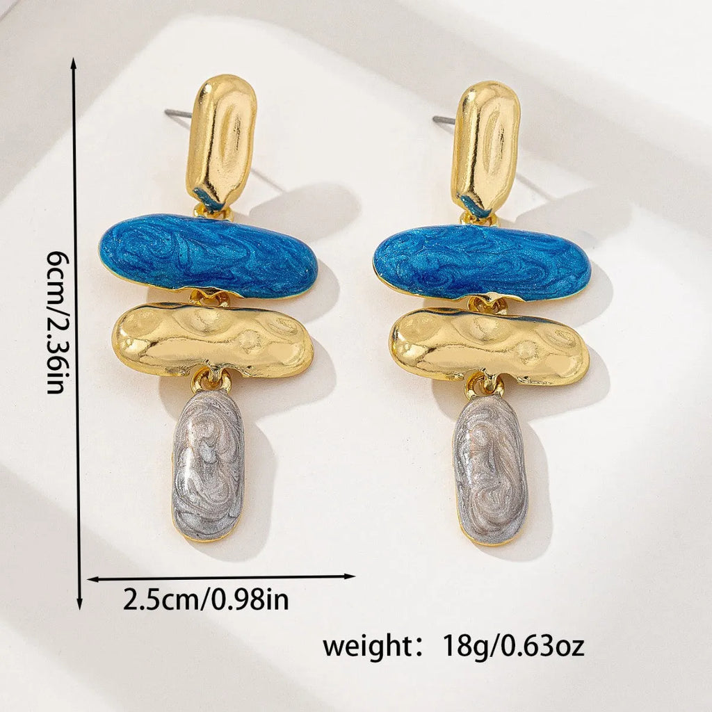 A pair of simple geometric stud earrings with a multicolour metallic finish.