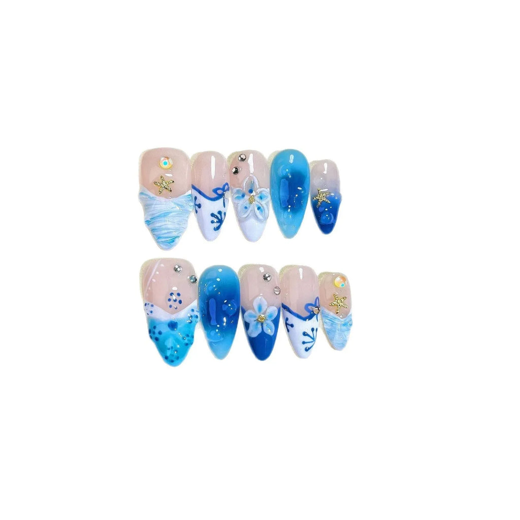 Set of blue carved plastic wearable artificial nails showing hand-painted summer ice design, laid out in sizes XS, S, M, L