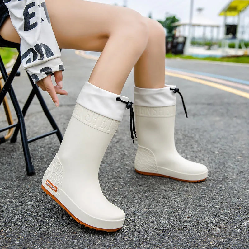 Women's non-slip PVC rain boots in apricot, black, brown and pink colours with wear-resistant soles