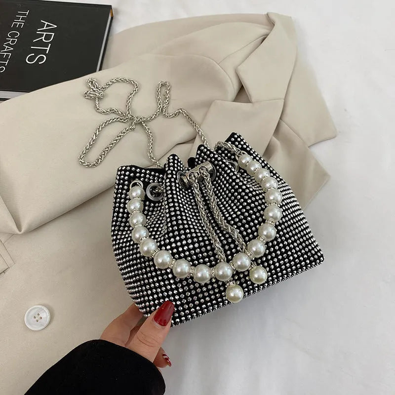 Women's soft PU light diamond decorated crossbody shoulder bag with chain strap in bucket shape.