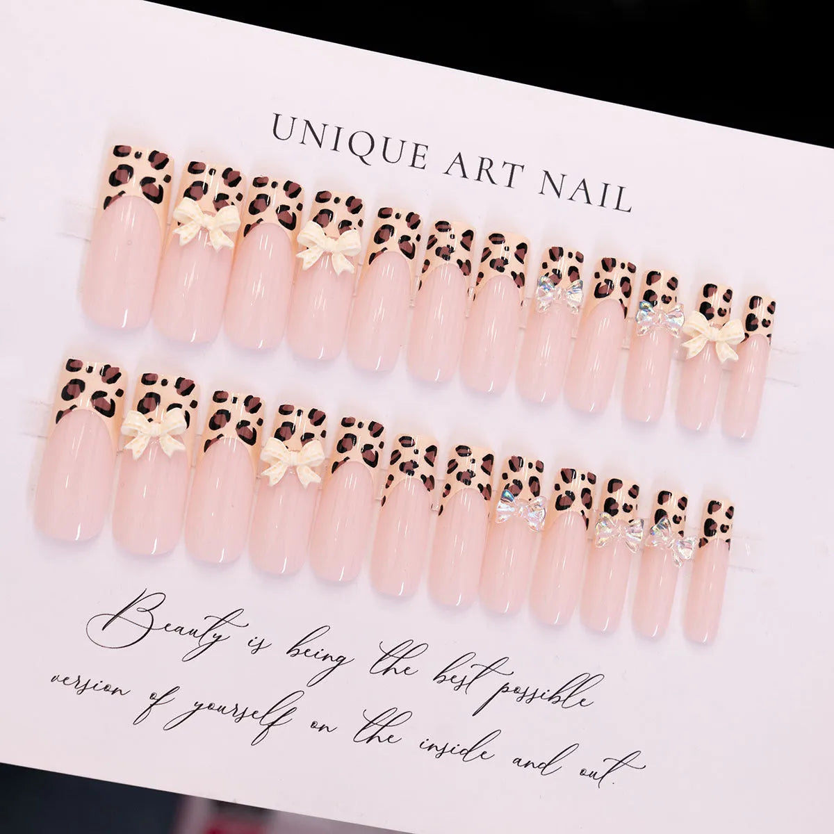 Leopard print butterfly design nail art stickers and gems on a white background.