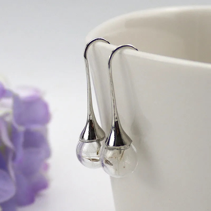 Transparent 16mm glass ball earrings with dandelion seed crystal design on silver French hooks