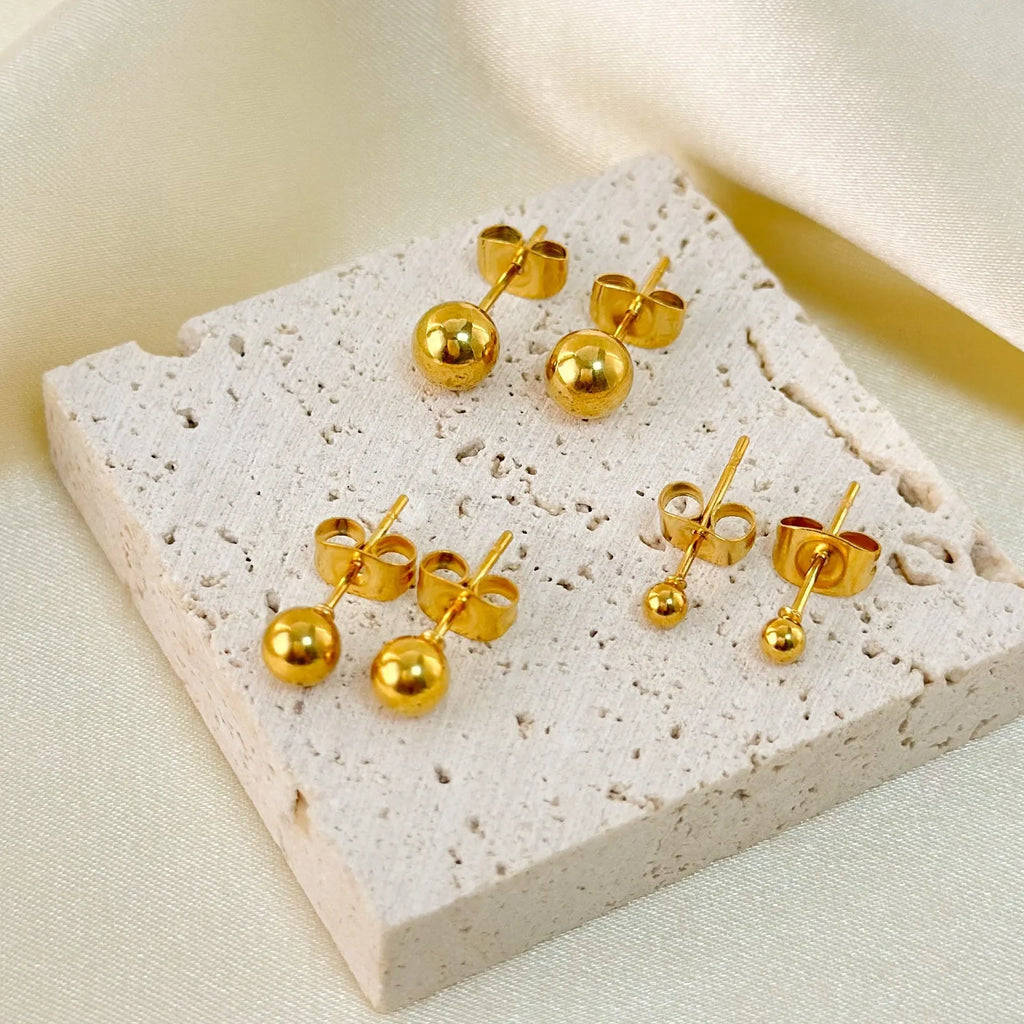 Stainless steel ball stud earrings in gold and silver colours with geometric round design