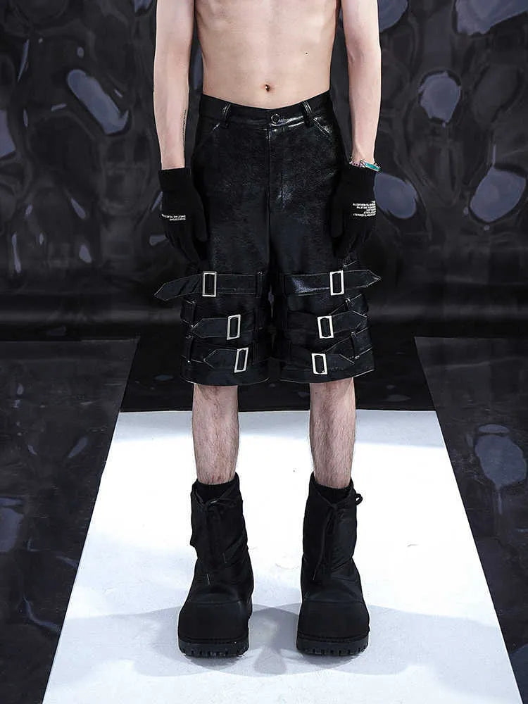 Black men's PU leather-look cropped shorts with a medium-low waist on a mannequin.
