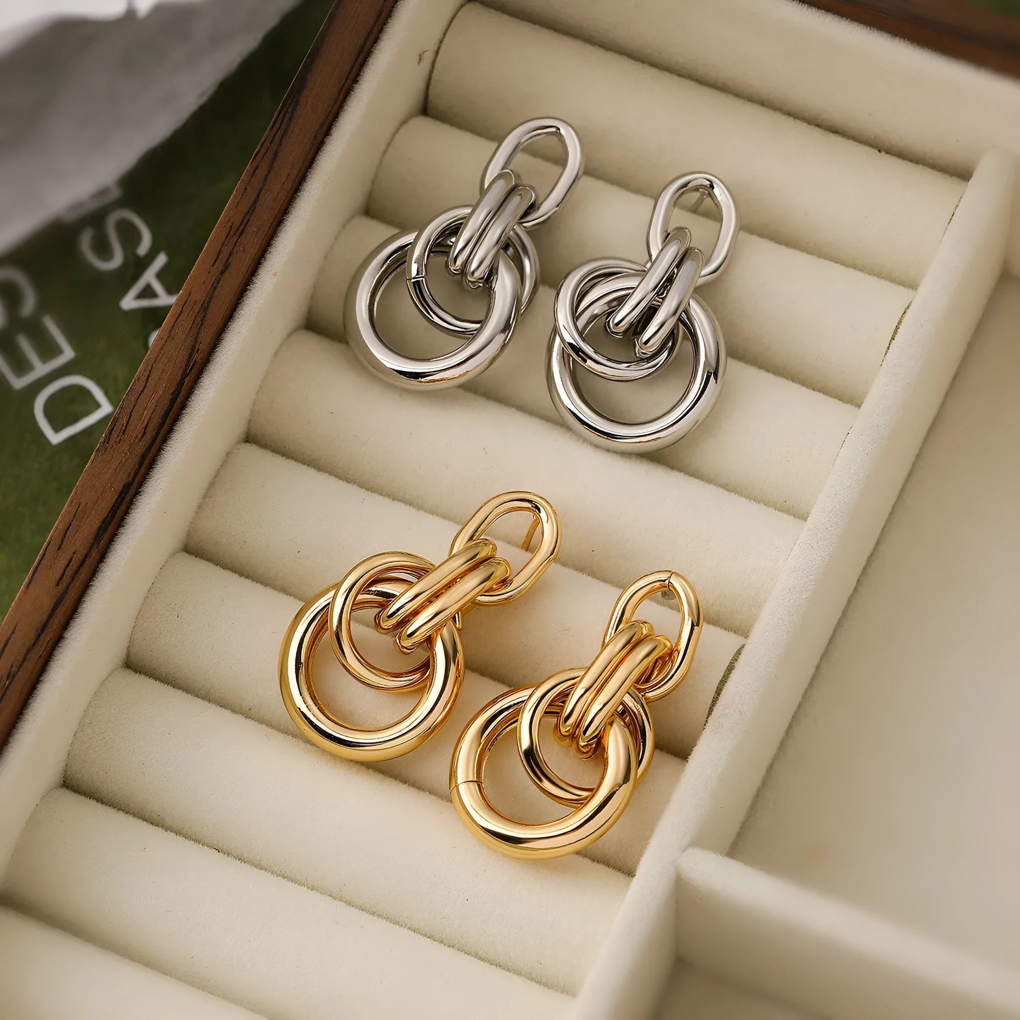 A pair of real gold coloured geometric earrings with an irregular shape, made from copper, style wild.