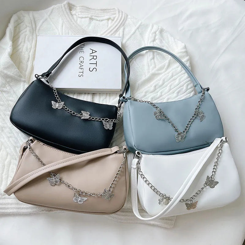 Women's black PU butterfly chain underarm handbag with crossbody strap, shown in a horizontal square shape.