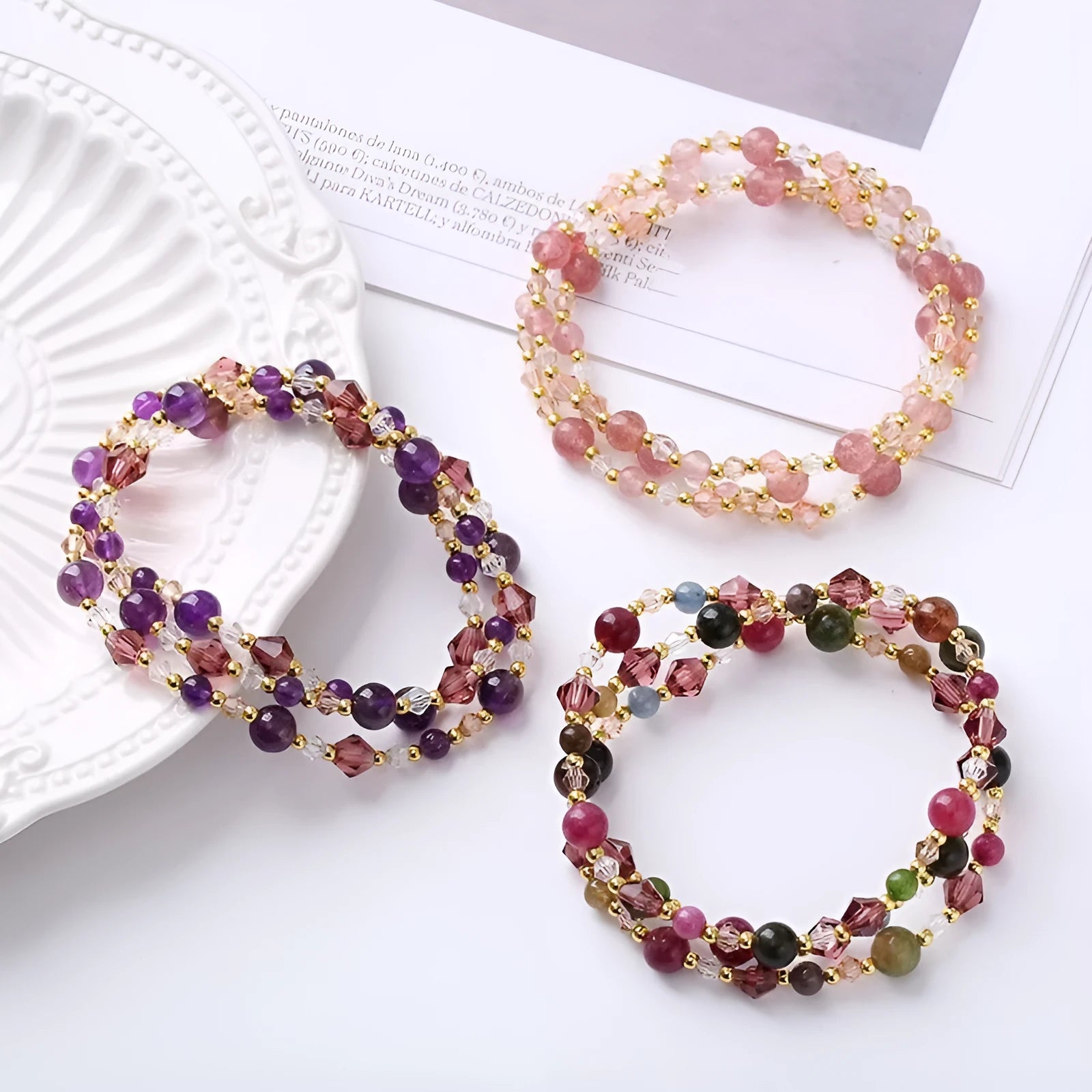Close-up of a handmade three-stone crystal bracelet with an adjustable cord, shown in a choice of gemstone colours.