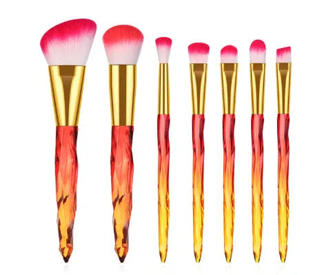 Ten crystal-handle foundation makeup brushes with synthetic bristles laid out flat
