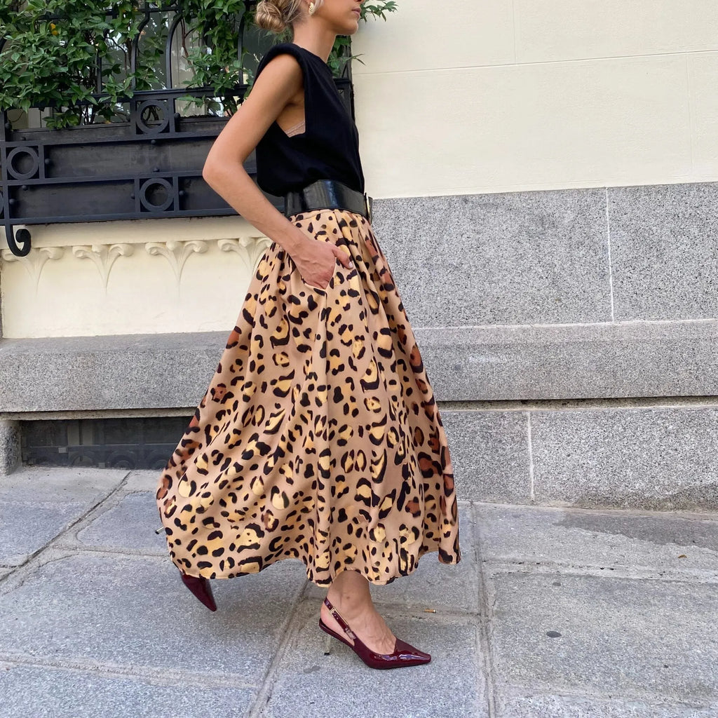 Brown leopard print women's A-line long skirt with a big hem on a hanger.