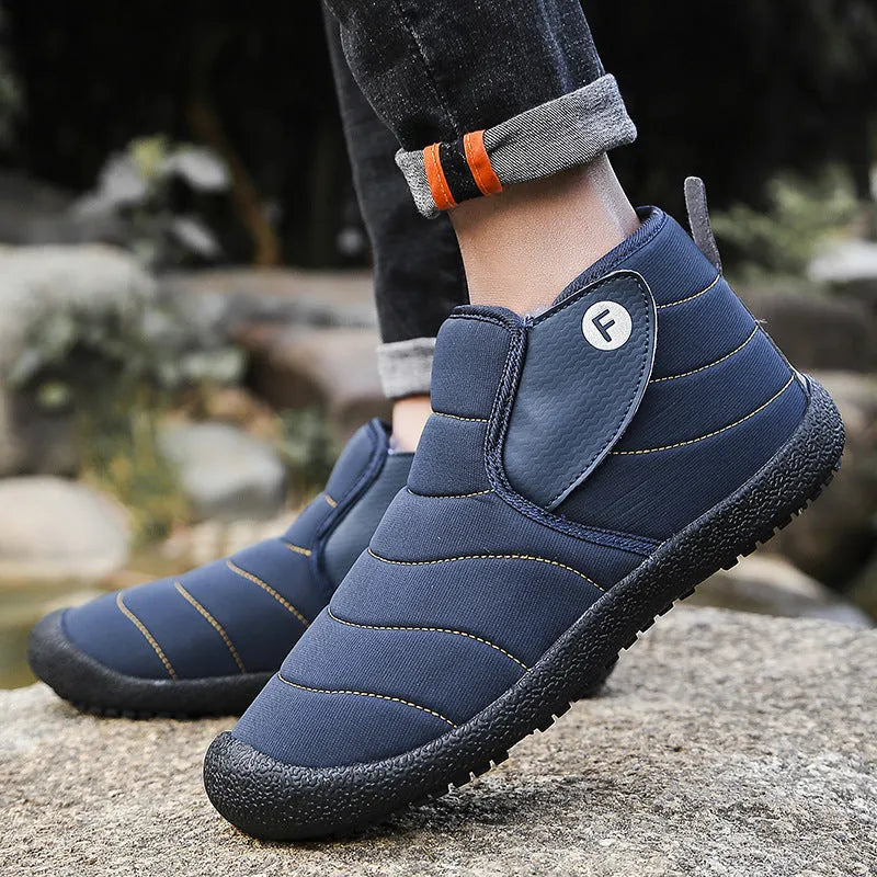 Men's thick cotton snow boots with a non-slip rubber sole in black, shown on a hard surface.