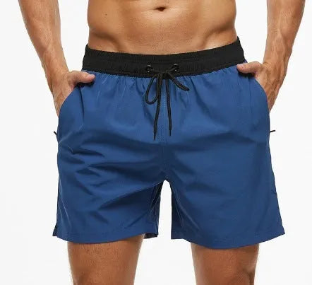 Men's blue drawstring athletic shorts with a zipper pocket and stitching detail on the waistband