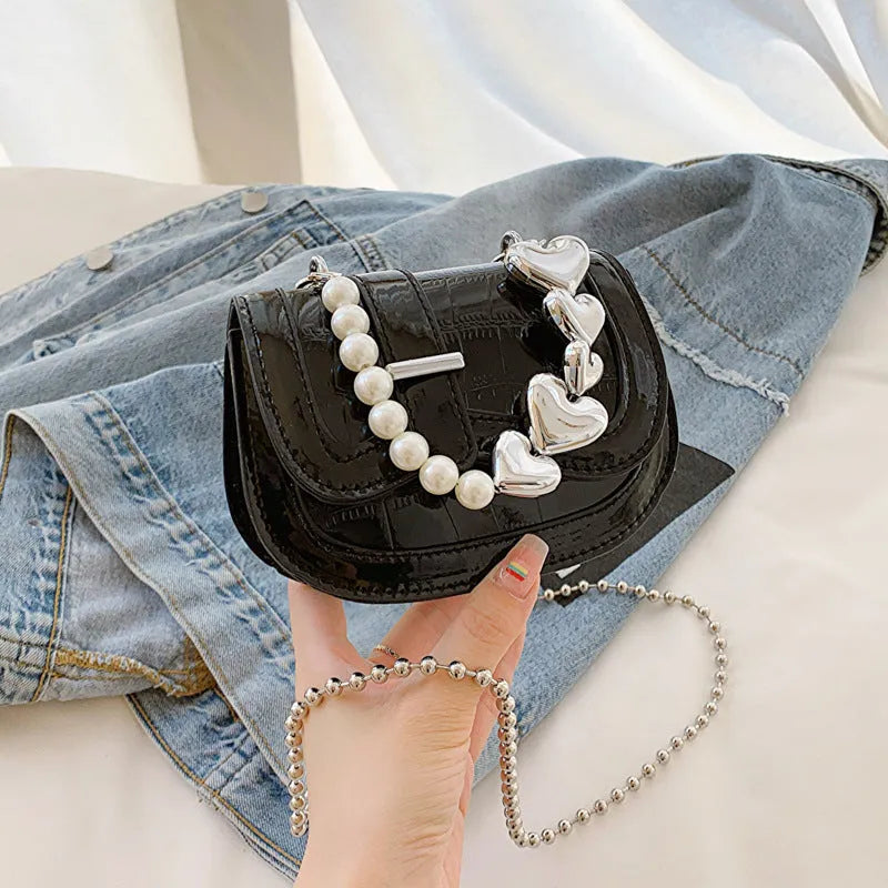 Horizontal square mini saddle bag in PU leather with sandwich pocket detail and adjustable shoulder strap
