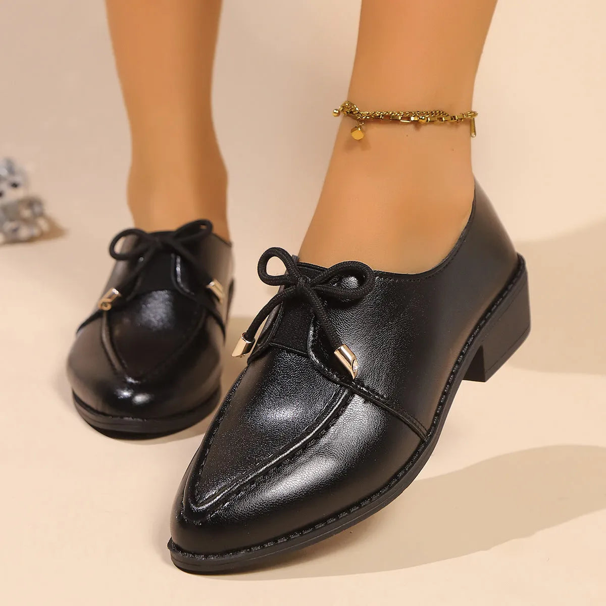 Women's British-style leather shoes with a decorative bow, rubber sole, and pointed toe.
