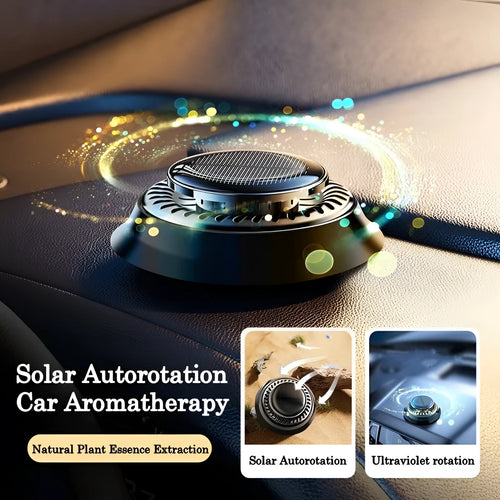 Solar powered kinetic car air freshener with rotating double rings on vehicle dashboard