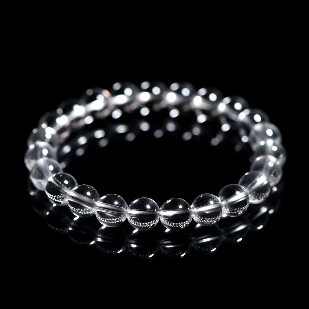 Natural white crystal bead bracelet with geometric design and round beads in various sizes.