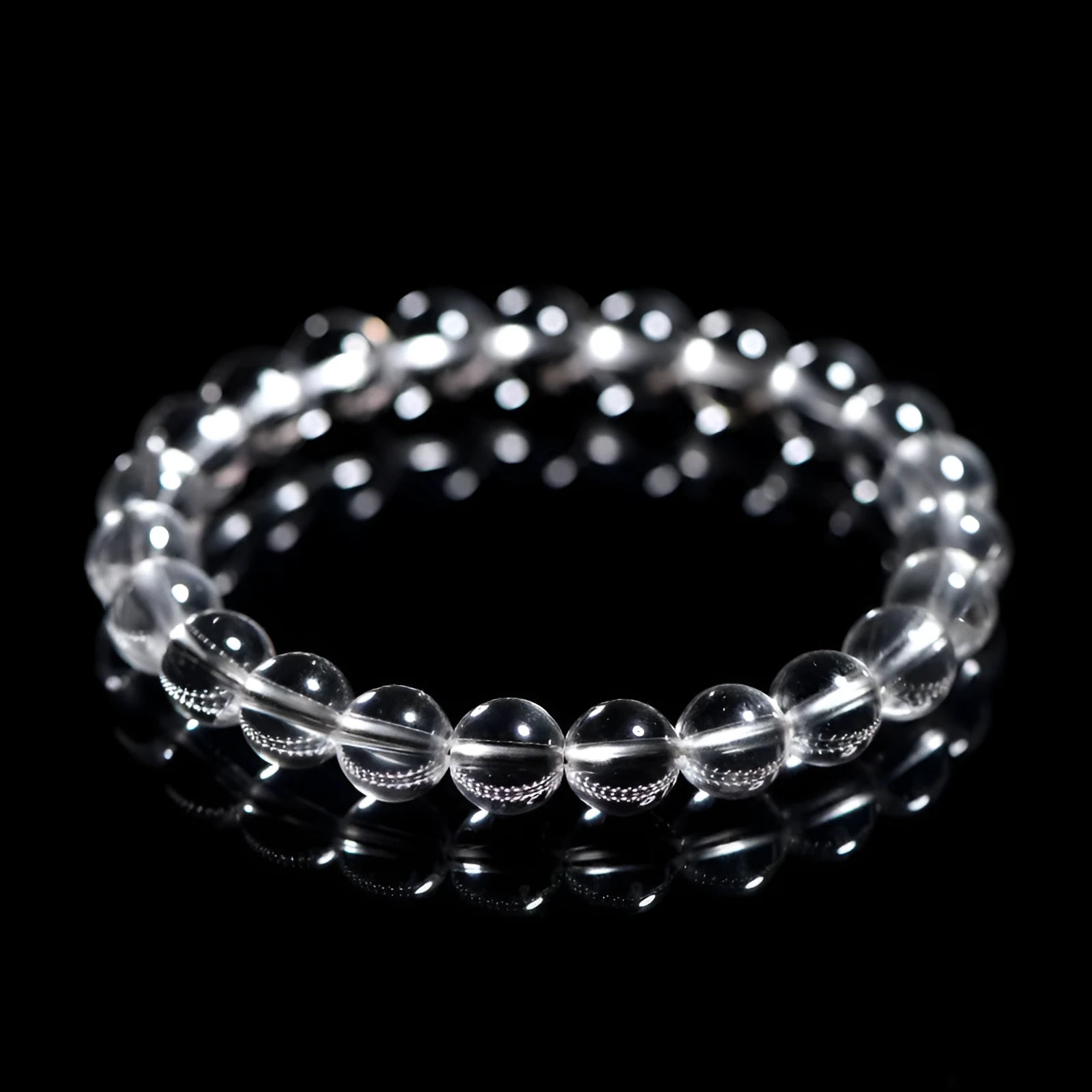 Natural white crystal bead bracelet with geometric design and round beads in various sizes.