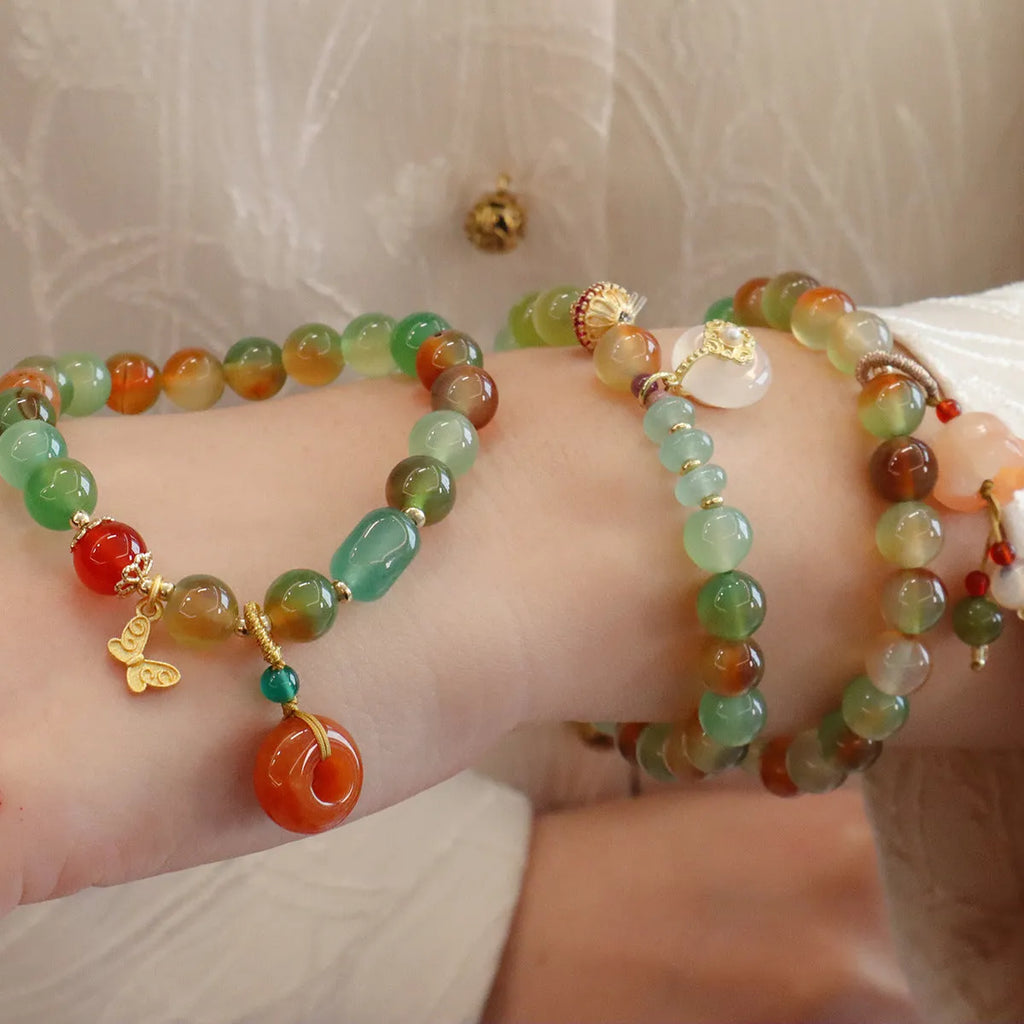 Natural peacock green agate bracelet with 8mm beads and butterfly peace buckle on white background