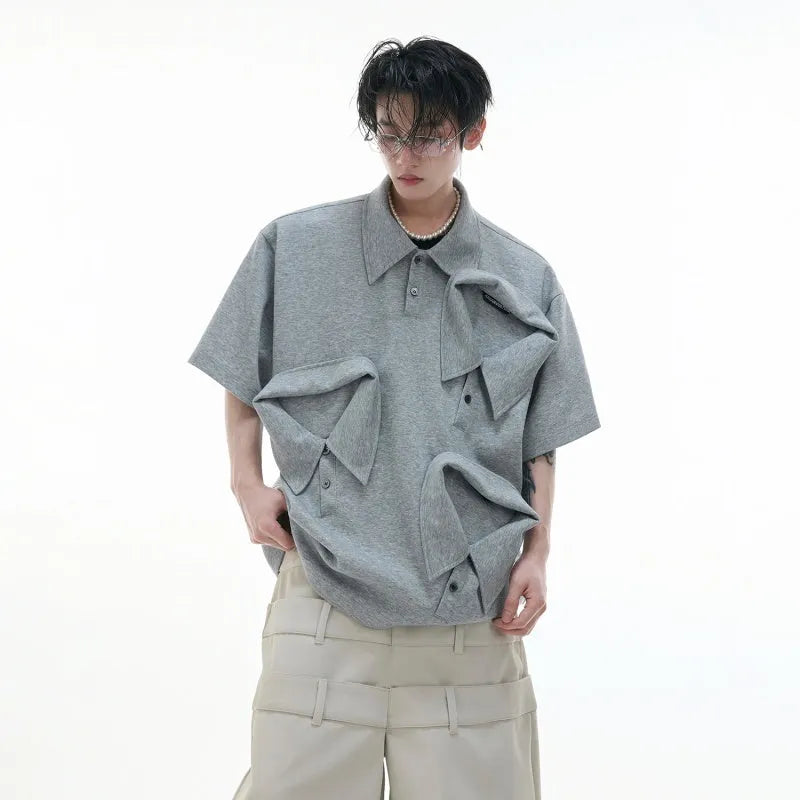 Men's black polo shirt with a deconstructed collar and geometric pattern, loose fit.