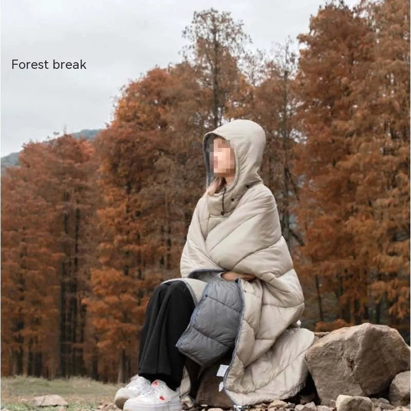 Grey adult-sized outdoor cloak sleeping bag worn as a cape, showing its 200x140cm dimensions.