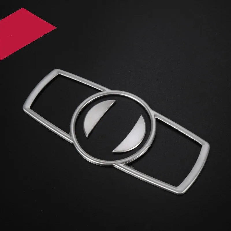 Silver ABS plastic decorative interior sticker for BMW 5 Series headlight switch frame.