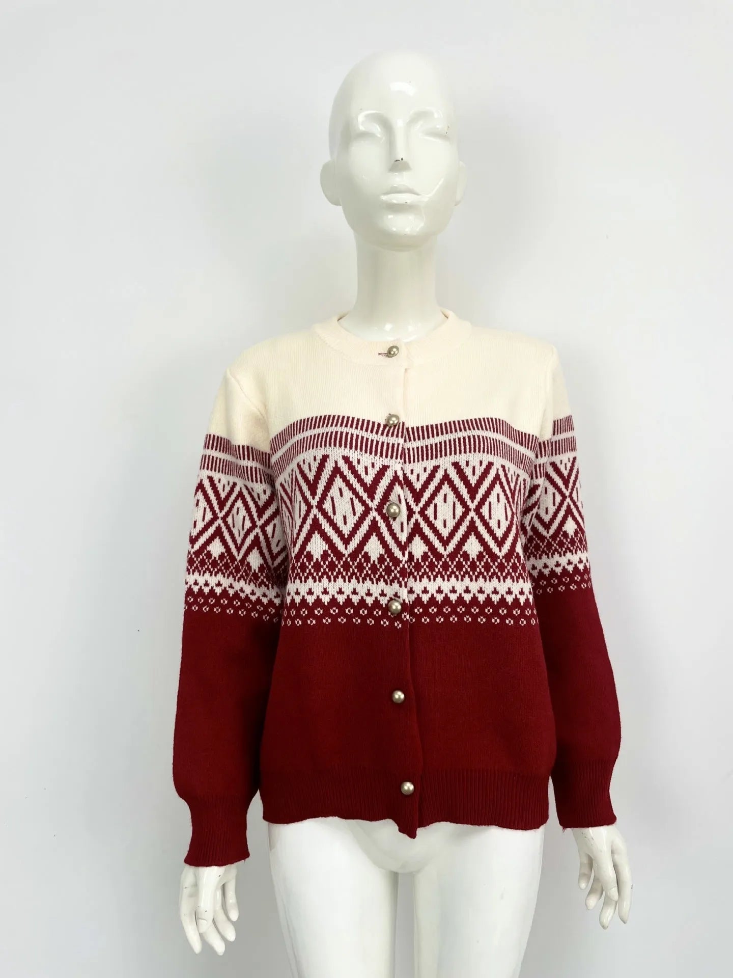 Red women's alpaca wool cardigan with grey diamond knit pattern and long sleeves.
