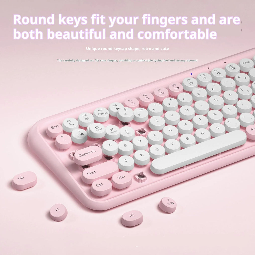 Pink dual-mode wireless Bluetooth mute portable keyboard with 84 keys and ABS construction on a desk