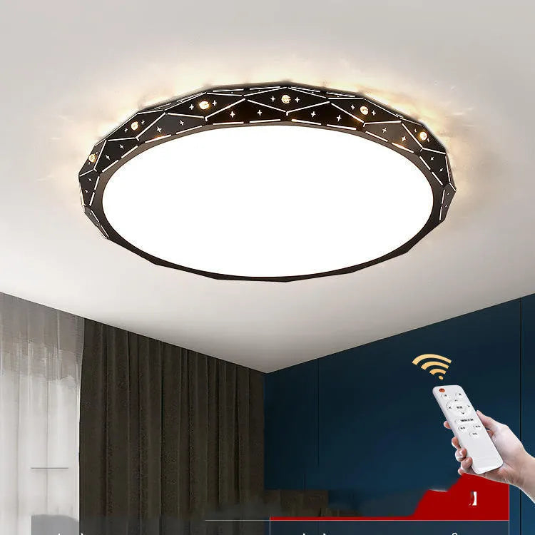 Round black and white framed LED ceiling light fixture for room installation.