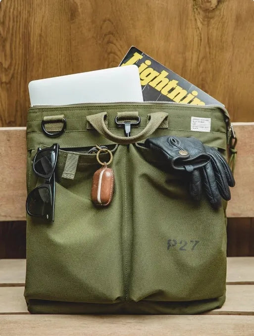 Canvas crossbody messenger bag in military green colour with shoulder strap and hard handle