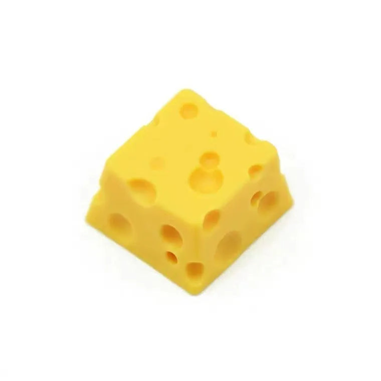 Yellow resin cheese artisan keycap for mechanical keyboards on a white background.