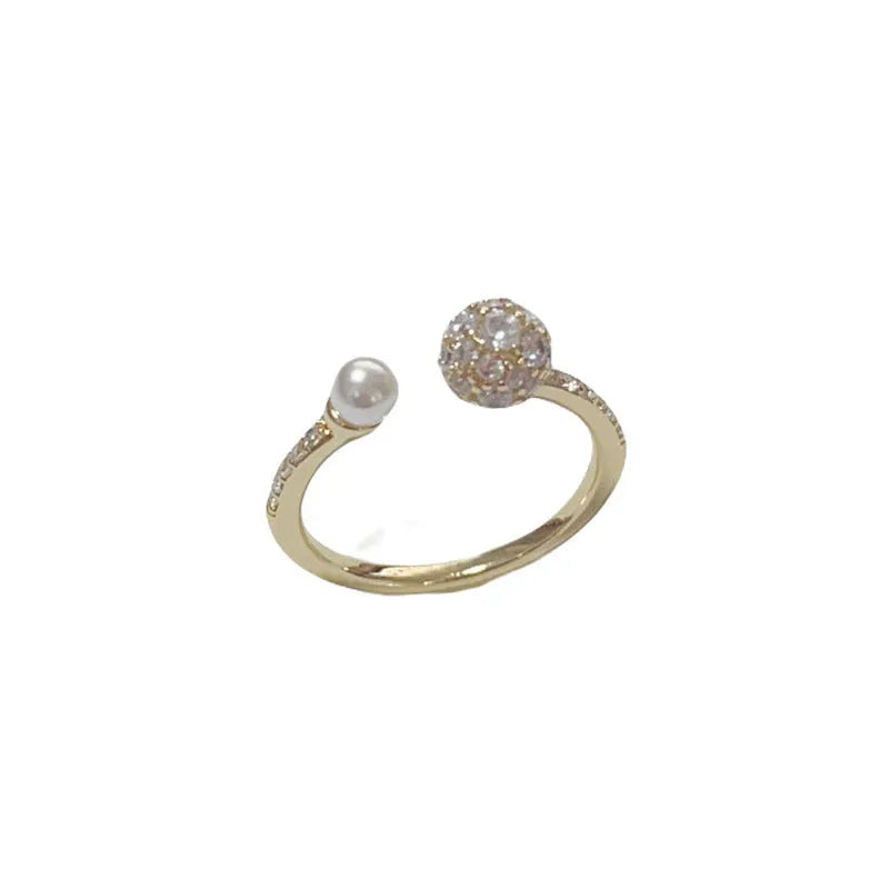 Gold plated open-end ring with round zircon accents on a geometric copper band