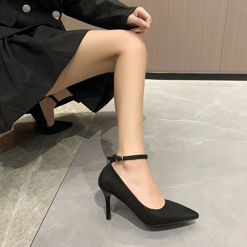 Women's black stiletto heel pump shoe with a silver buckle detail on the front.