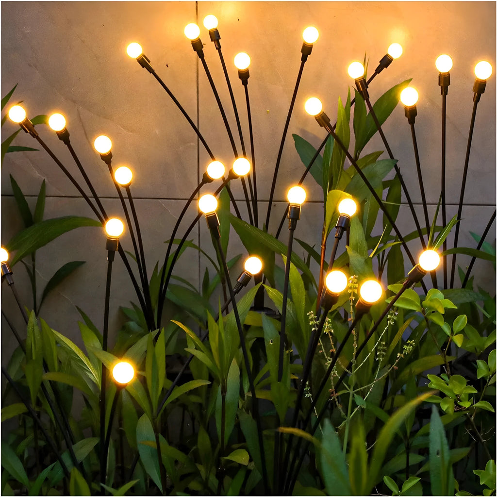 Solar-powered LED ground spike garden light with multiple heads and stainless steel soil plug.