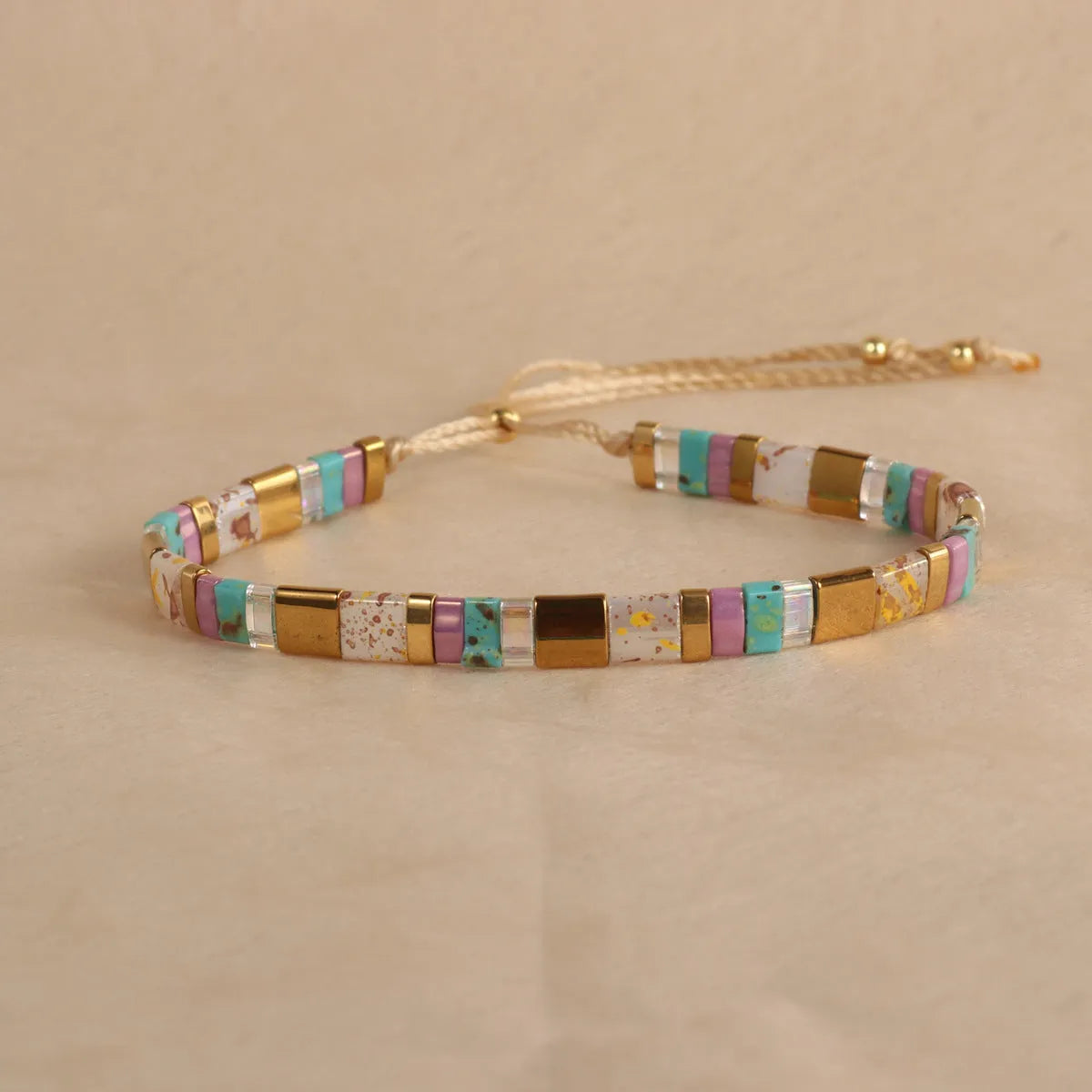 Geometric glass and coloured glaze bead bracelet in milky white, black, green, blue, or red