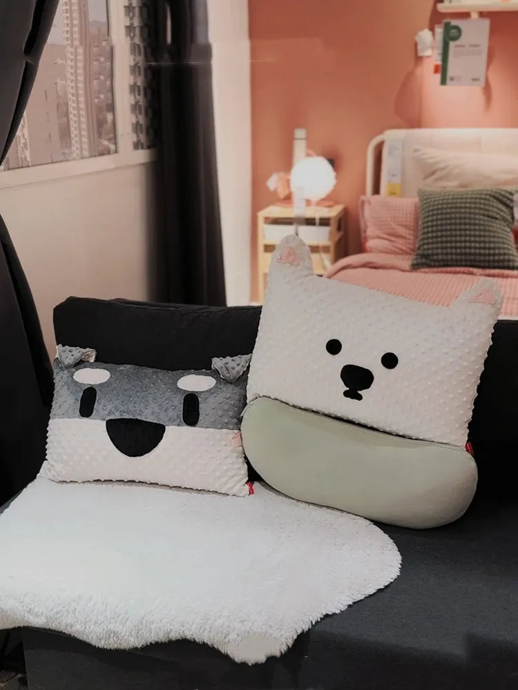 Grey or white West Highland puppy shaped pillow on a sofa, 50cm long.