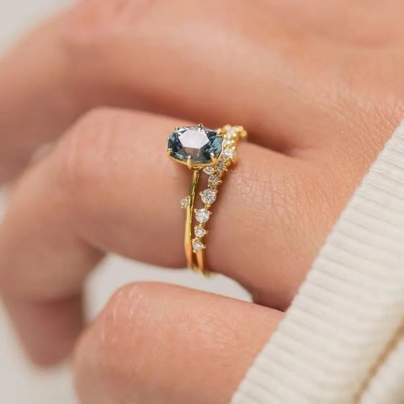Gold-plated women's ring with green zircon stone in floral design, showing detailed metalwork and stone setting