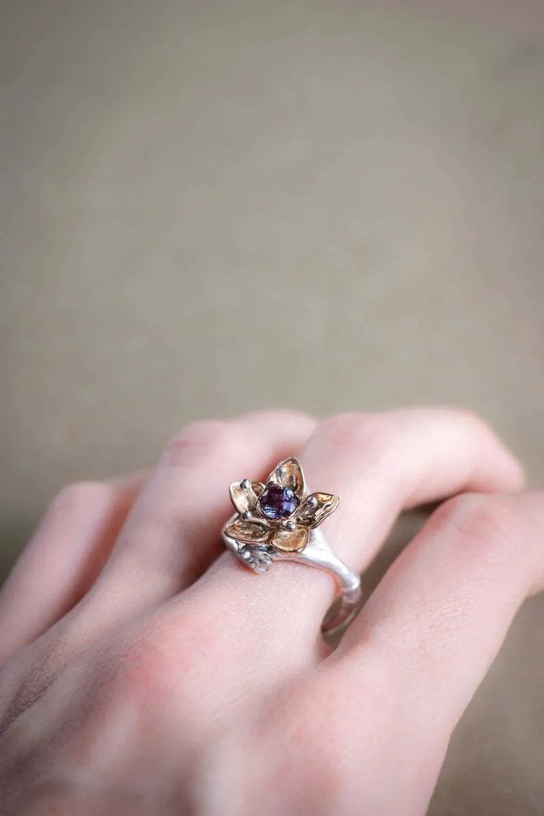Silver two-tone floral geometric women's alloy ring shown on a finger.