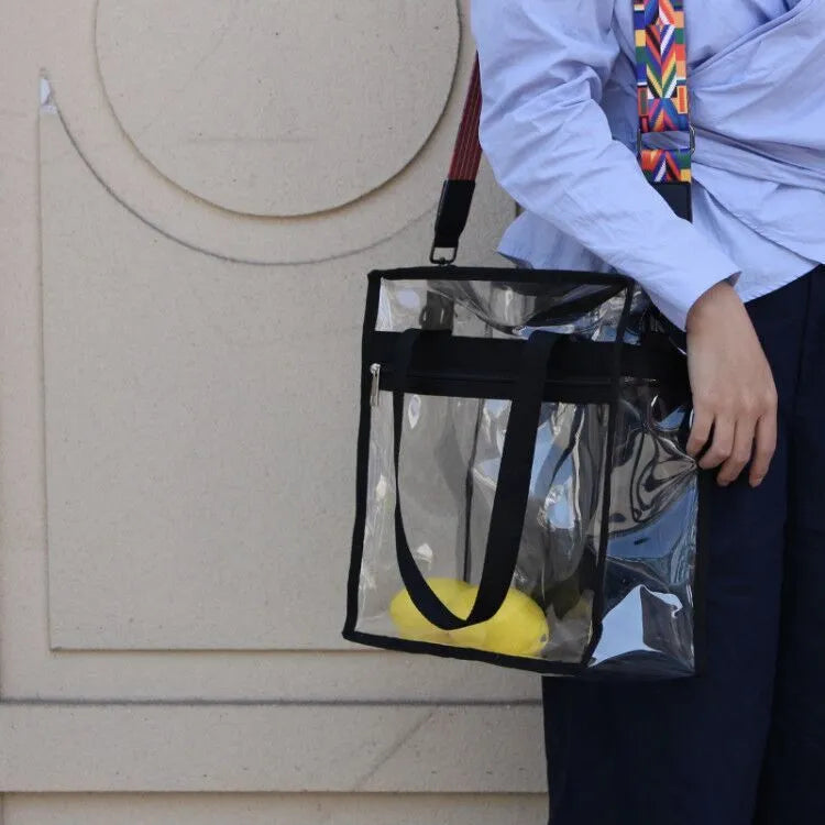 Women's PVC messenger bag with transparent front compartment and crossbody strap in a selection of colours.
