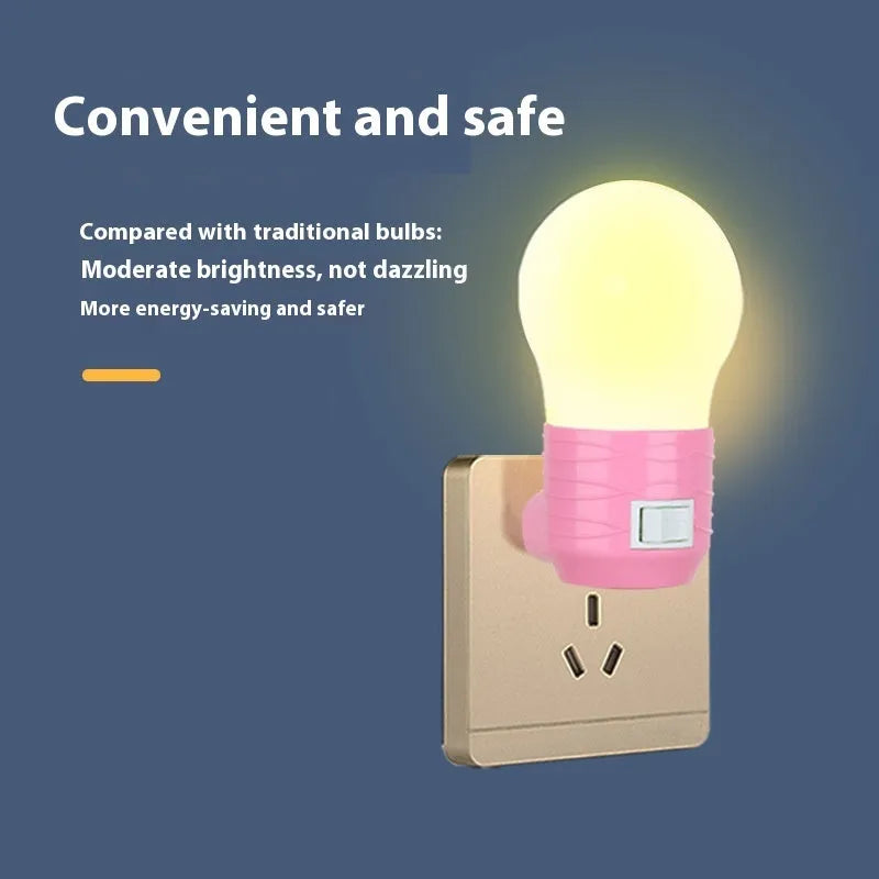 Plug-in bedside baby night light in white, blue, or pink shell with round design on a table