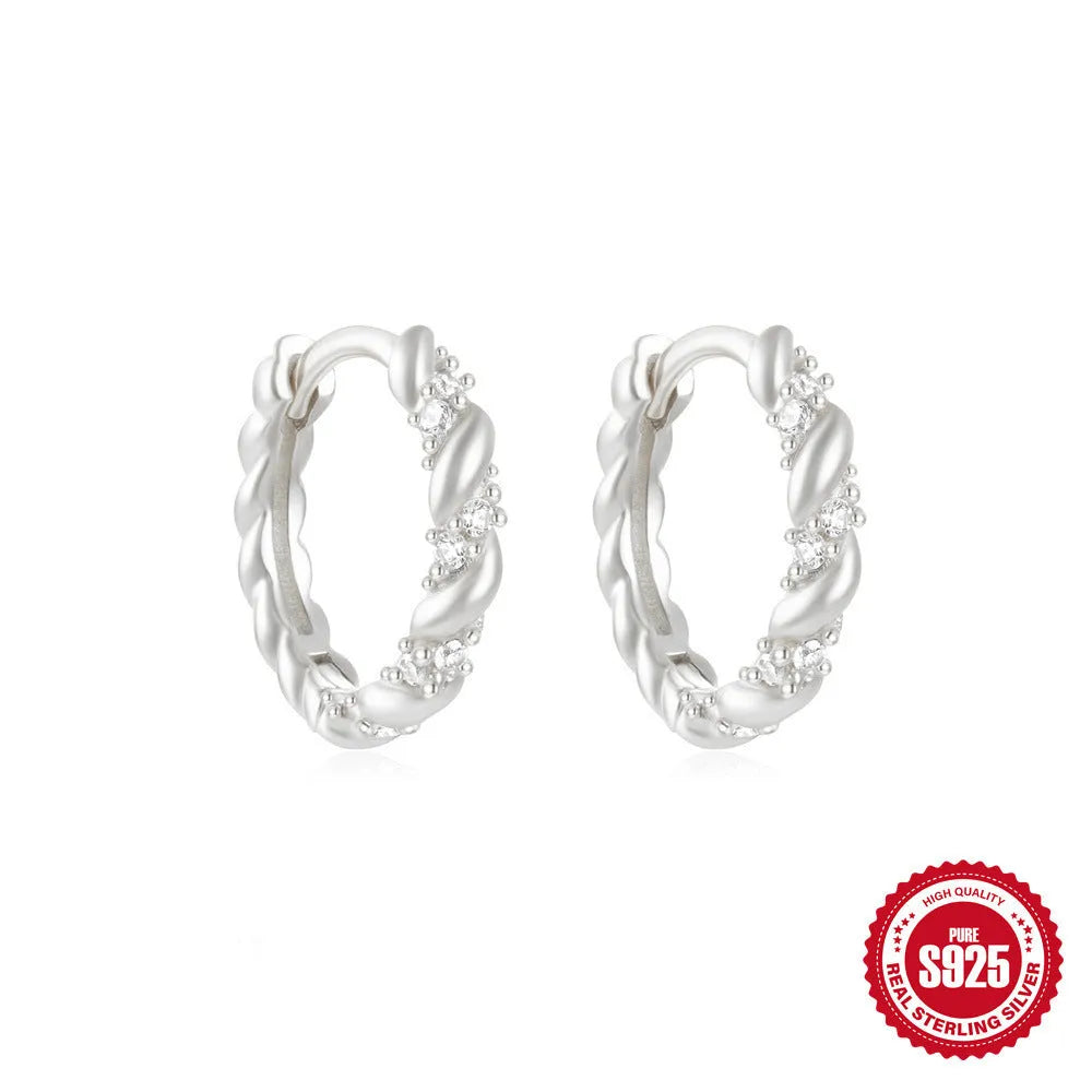 Sterling silver geometric stud earrings with small round design elements in gold or silver finish